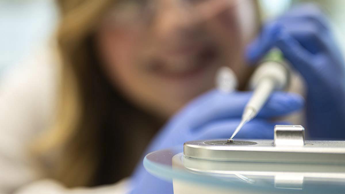 Close up of pipette with a drop of liquid.